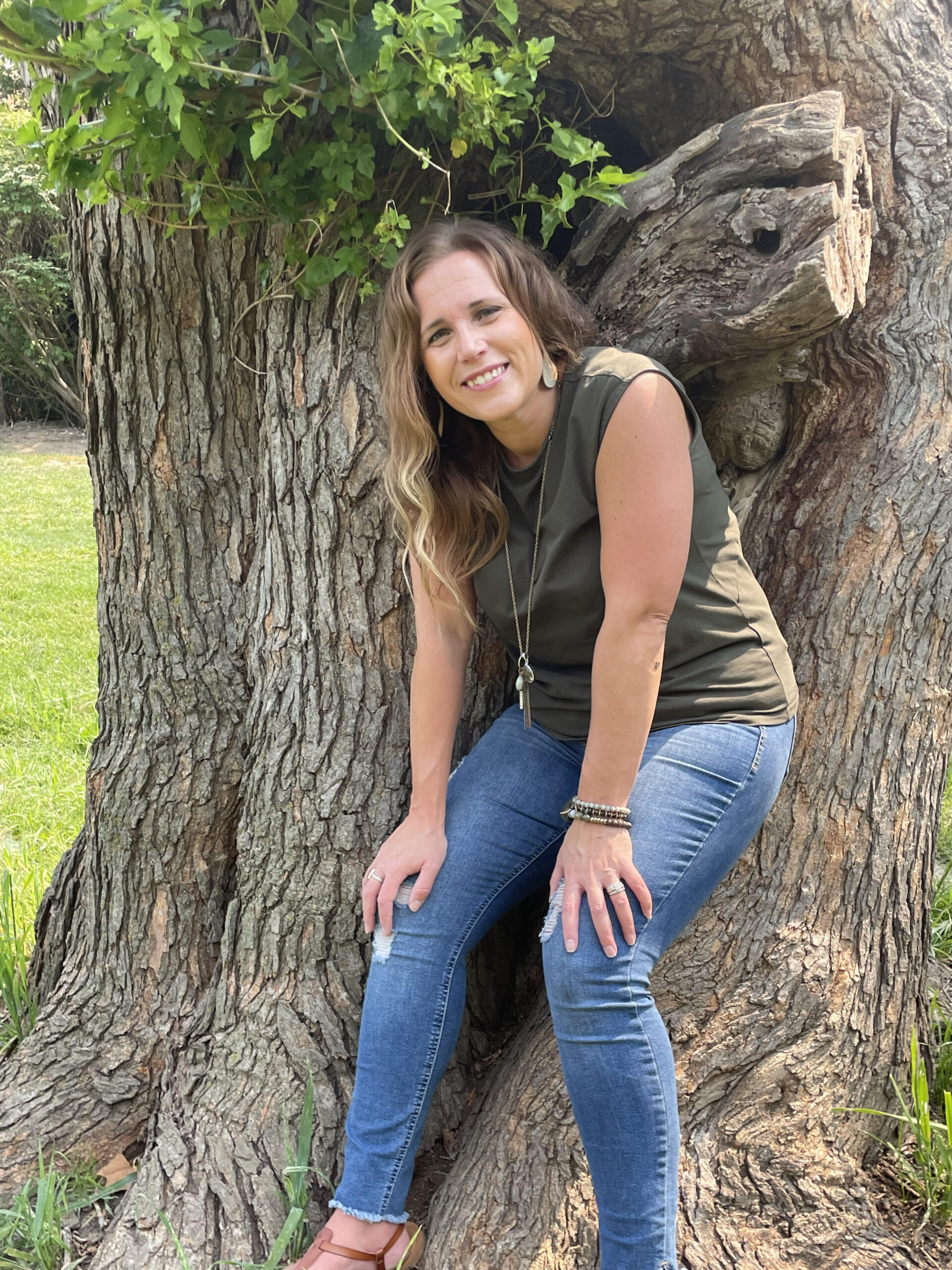 amber leaning on a tree